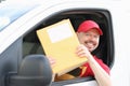 Smiling male courier driver holds mail in his hands Royalty Free Stock Photo