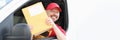 Smiling male courier driver holds mail in his hands Royalty Free Stock Photo