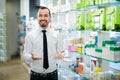 Smiling male customer looking for right medicine Royalty Free Stock Photo