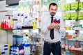 Smiling male customer looking for right medicine Royalty Free Stock Photo