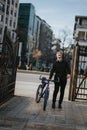 Joyful young man with bicycle at city gate enjoying a sunny day Royalty Free Stock Photo