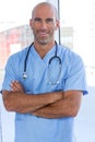 Smiling male doctor looking at camera with arms crossed Royalty Free Stock Photo