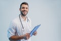 Smiling male doctor with stethoscope and clipboard Royalty Free Stock Photo