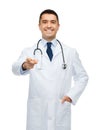 Smiling male doctor in white coat pointing at you Royalty Free Stock Photo