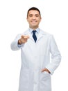 Smiling male doctor in white coat pointing at you Royalty Free Stock Photo