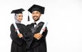 Smiling male and female graduate students wearing togas holding certificates Royalty Free Stock Photo