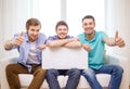 Smiling male friends holding white blank board Royalty Free Stock Photo