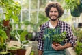 Smiling male gardener holding potted plant Royalty Free Stock Photo