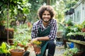 Smiling male gardener holding potted plant Royalty Free Stock Photo