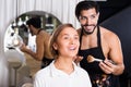 Male makeup artist applying cosmetics for female Royalty Free Stock Photo