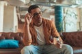 Smiling male manager in eyeglasses drinking coffee during break time in coworking Royalty Free Stock Photo