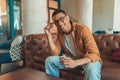 Smiling male manager in eyeglasses drinking coffee during break time in coworking Royalty Free Stock Photo