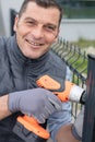 smiling male manual worker in protective helmet with drill machine Royalty Free Stock Photo