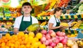 Smiling male merchandiser with melon in hands at supermarket