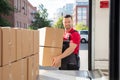 Smiling Male Mover Loading The Cardboard Boxes In Van Royalty Free Stock Photo