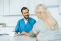 smiling male nurse measuring blood pressure to