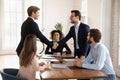 Smiling male partners handshake closing deal at briefing Royalty Free Stock Photo