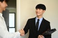 Smiling male real estate agent or financial advisor shaking hands with his clients, making purchase or greeting Royalty Free Stock Photo