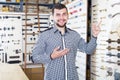 Smiling male seller demonstrating door knobs