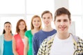 Smiling male student with group of classmates