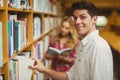 Smiling male student taking book Royalty Free Stock Photo