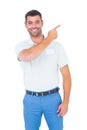 Smiling male technician pointing at copy space on white background
