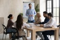 Smiling male trainer present project to colleagues at meeting Royalty Free Stock Photo