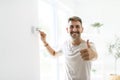 Smiling Man Adjusting Thermostat On Home Heating System Royalty Free Stock Photo