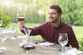 Smiling man admires red wine Royalty Free Stock Photo