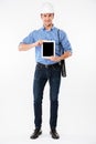 Smiling man architect in building helmet holding blank screen tablet Royalty Free Stock Photo