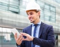 Smiling man architect in helmet working at the tablet Royalty Free Stock Photo