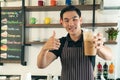 Smiling man barista with apron making coffee in his small cafe Royalty Free Stock Photo