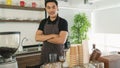 Smiling man barista with apron making coffee in his small cafe Royalty Free Stock Photo