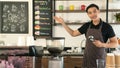 Smiling man barista with apron making coffee in his small cafe Royalty Free Stock Photo