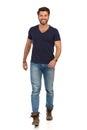 Smiling Man In Blue T-shirt, Jeans And Boots Is Walking Towards Camera Royalty Free Stock Photo