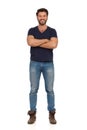 Smiling Man In Boots, Jeans And Blue T-shirt Is Standing With Arms Crossed Royalty Free Stock Photo