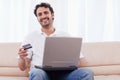 Smiling man buying online Royalty Free Stock Photo