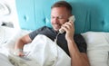 Smiling man calling on reception in hotel, want to order lunch in room