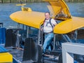 Smiling man with casual clothes disembarking from a taxi boat