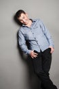 Smiling man casually leaning against the wall Royalty Free Stock Photo