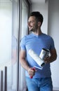 Man catching a short break while doing some housework