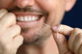 Smiling man is cleaning interdental space with dental floss. Royalty Free Stock Photo