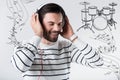 Smiling man closing his eyes while listening to music in headphones Royalty Free Stock Photo