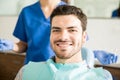 Smiling Man With Dentist Holding Dental Tools At Clinic Royalty Free Stock Photo