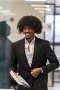 Smiling man with documents in a business setting. Royalty Free Stock Photo