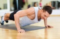 Smiling man doing push-ups in the gym Royalty Free Stock Photo