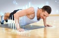 Smiling man doing push-ups in the gym