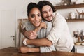 Smiling man dreamily embracing beautiful african american woman joyfully looking in camera together. Young international Royalty Free Stock Photo