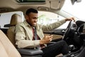 Smiling man or driver driving car and using smartphone.Transport, vehicle and technology concept Royalty Free Stock Photo