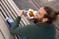 Smiling man eating chinese food on bench Royalty Free Stock Photo